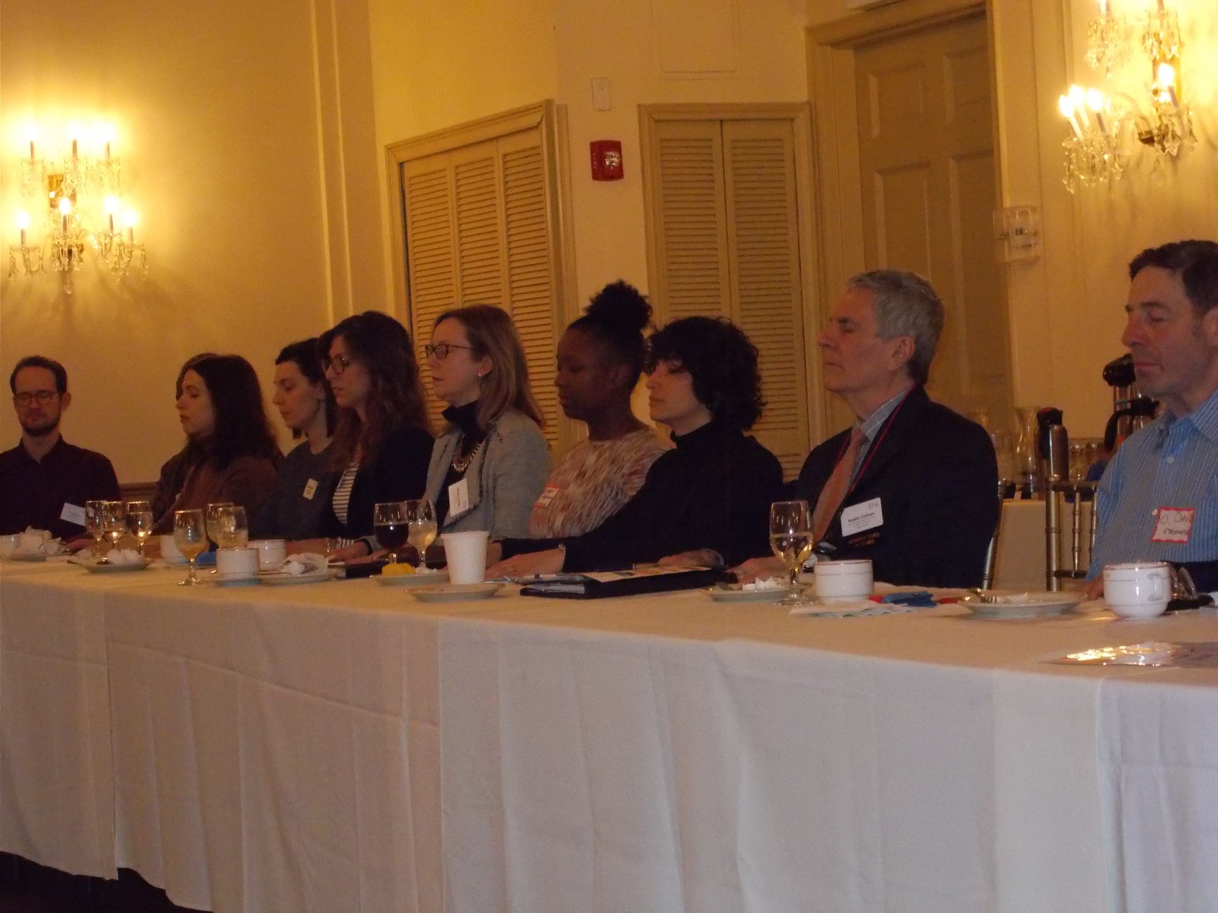 Business Networking Group No. 53 meditating together around their table in New York